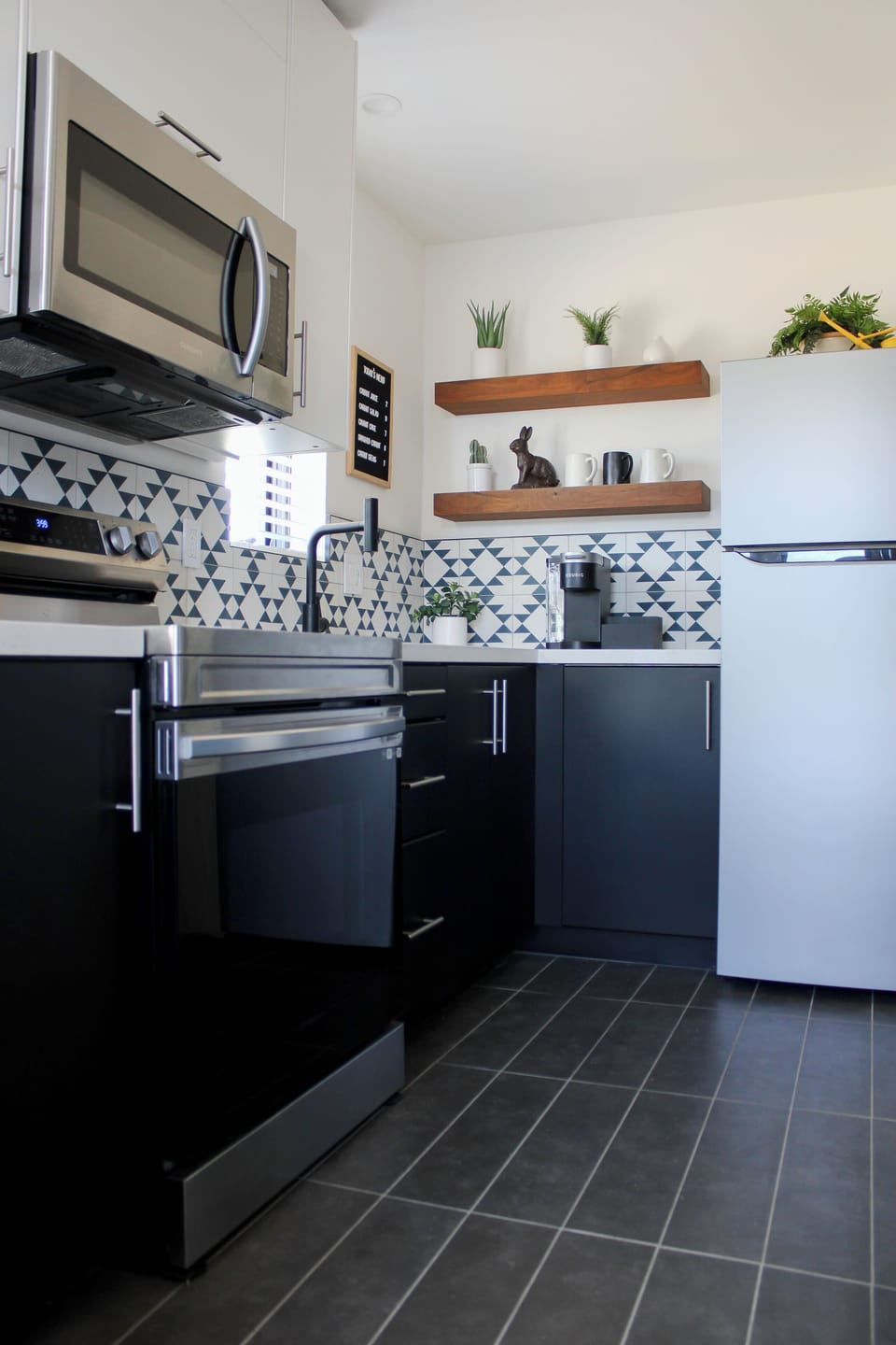 This fully equipped kitchen includes cooking utensils, plates, and more. 