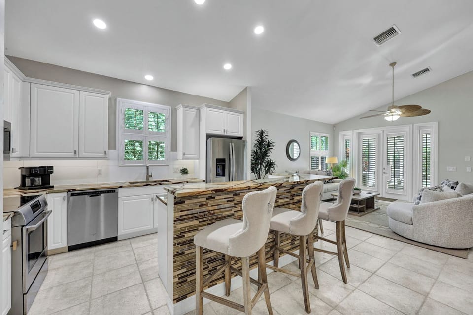 Open kitchen with island seating so everyone stays connected while cooking and lounging