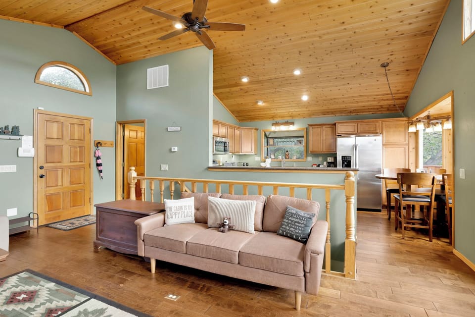 Charming living room flows into the kitchen and dining area, creating a warm, open layout perfect for gatherings, shared meals, and relaxed guest experiences.