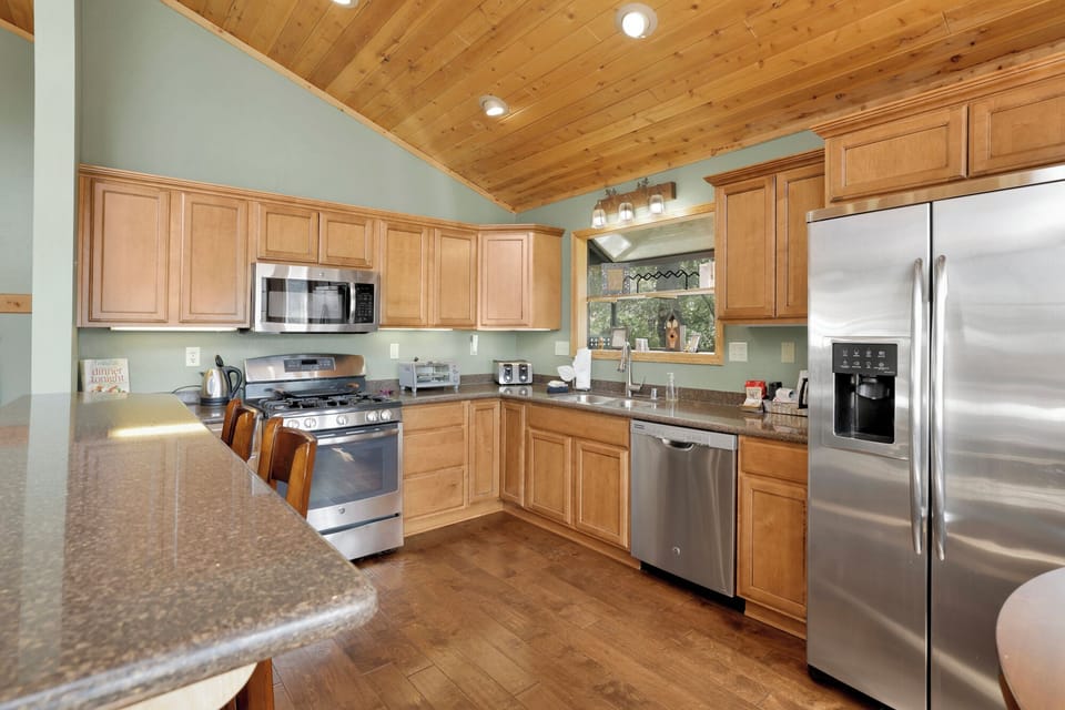 Spacious kitchen with ample room to cook that special meal, featuring modern appliances, generous counters, and a welcoming layout for culinary creativity