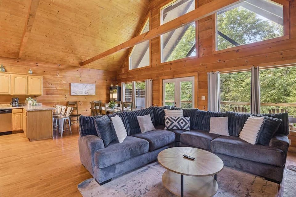 Living Room: Bask in natural light and unwind on plush seating with woodland views just outside!