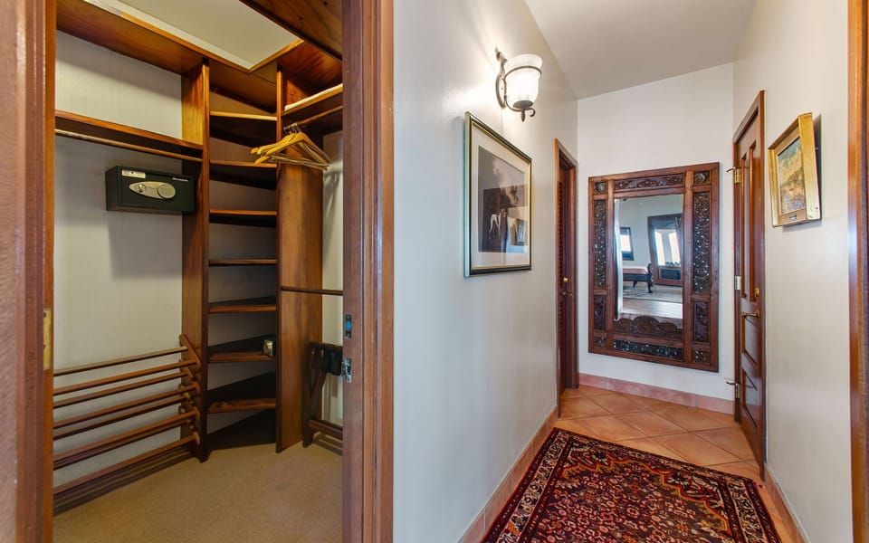 Hallway from the bedroom to the two primary bathrooms.