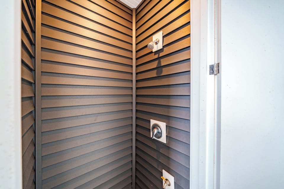 Enclosed outdoor shower for a refreshing experience.