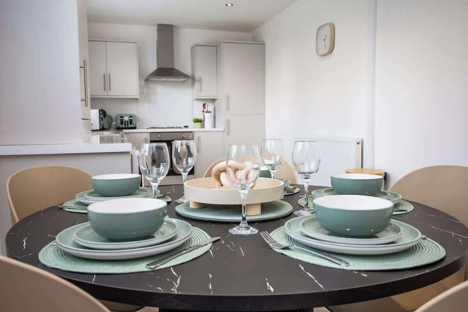 Bright dining area with a sleek kitchen just steps away
