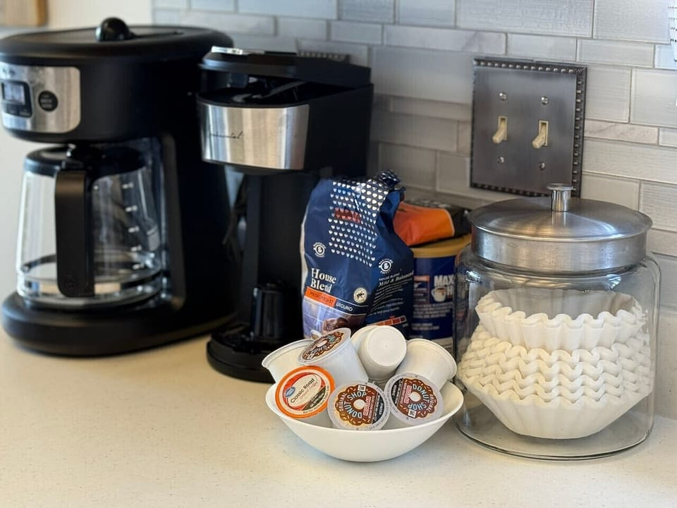 Fully stocked coffee station with drip coffee maker, K-cups, and essentials for easy mornings.