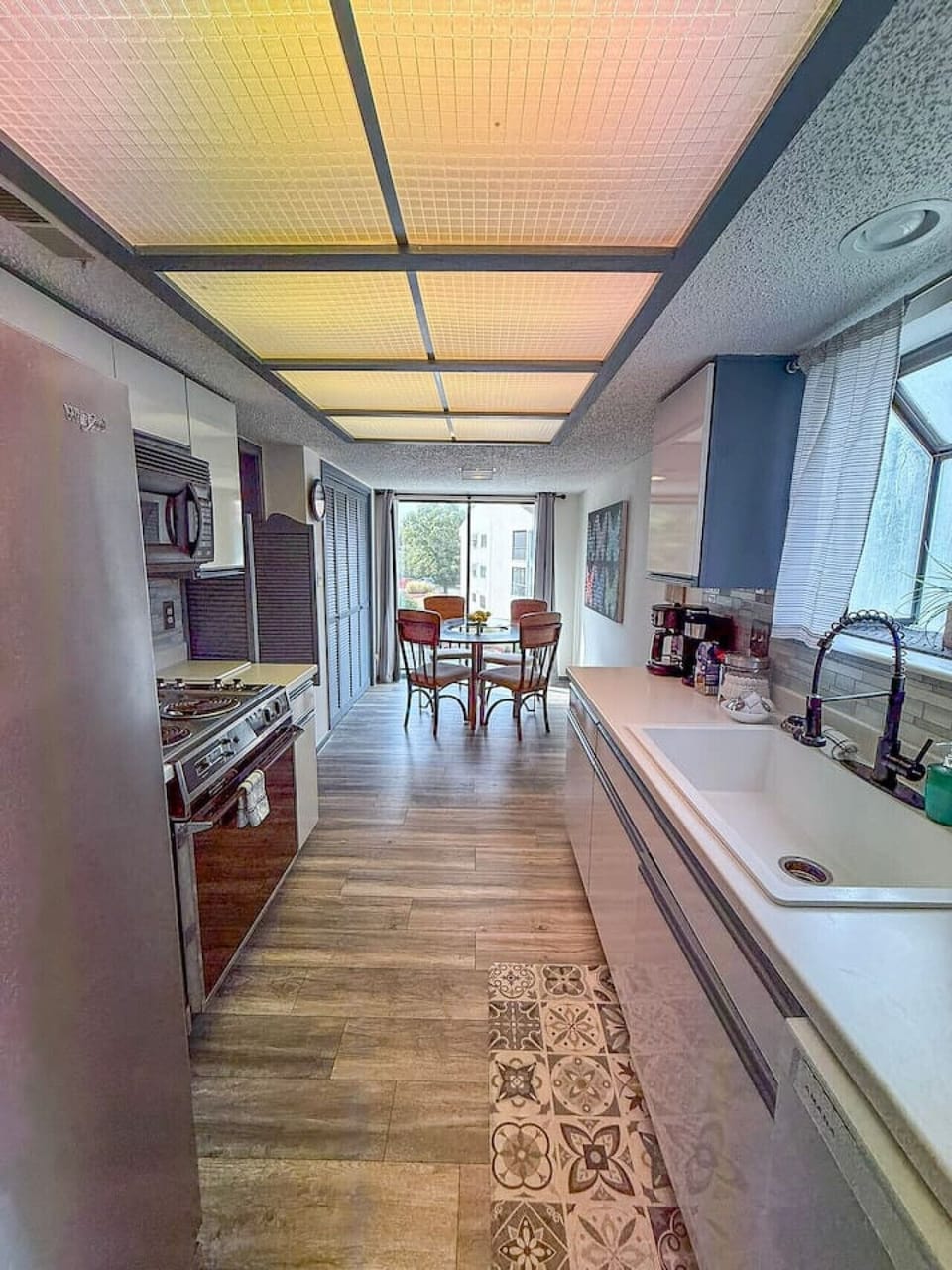 Bright open-concept kitchen with modern appliances and cozy dining nook.