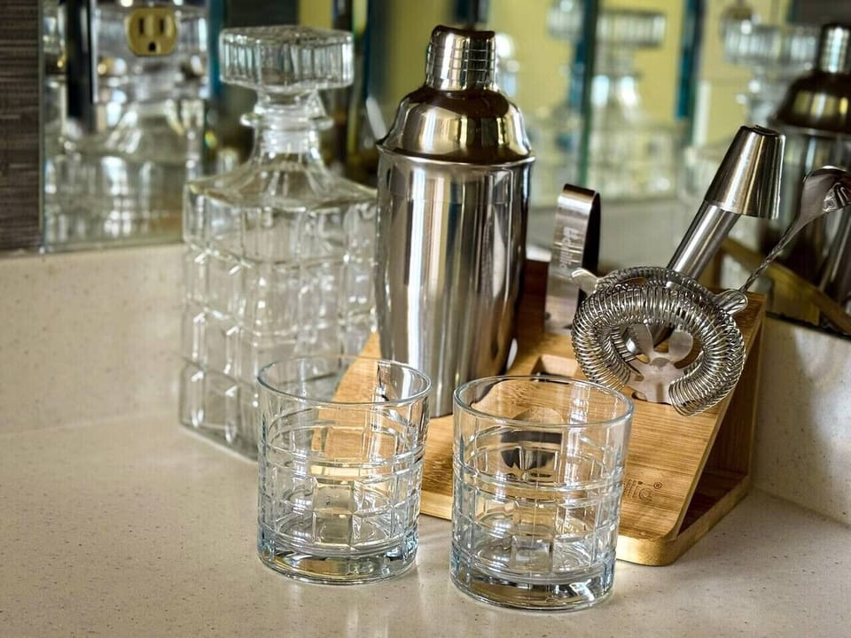 Stylish in-home bar setup with glassware and cocktail tools for relaxing evenings.