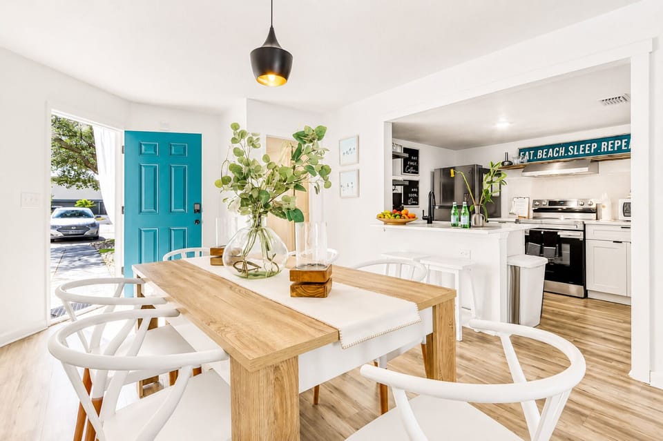 Bright dining space with stylish kitchen and cheerful coastal touches