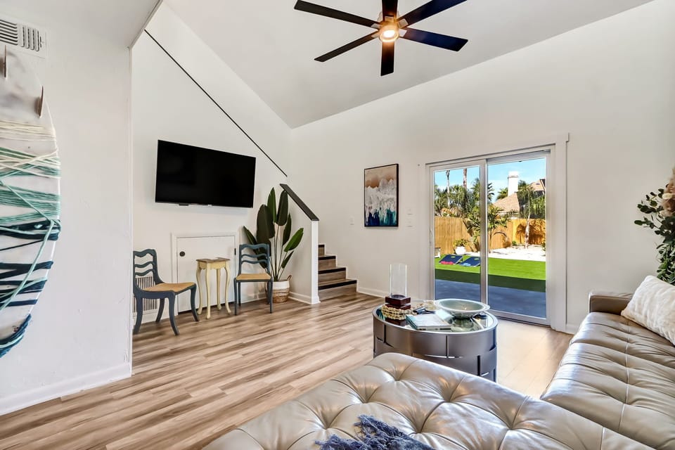 Bright open living space with comfy seating and backyard access.