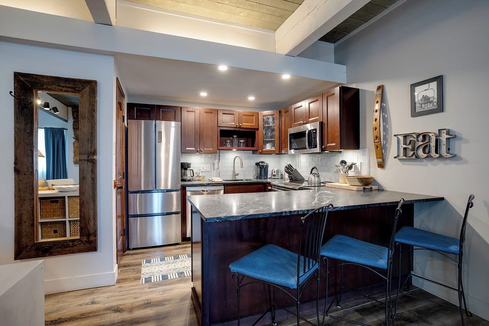 Your fully equipped kitchen features granite counters, stainless appliances, and a breakfast bar where you can sip morning coffee and plan adventures.