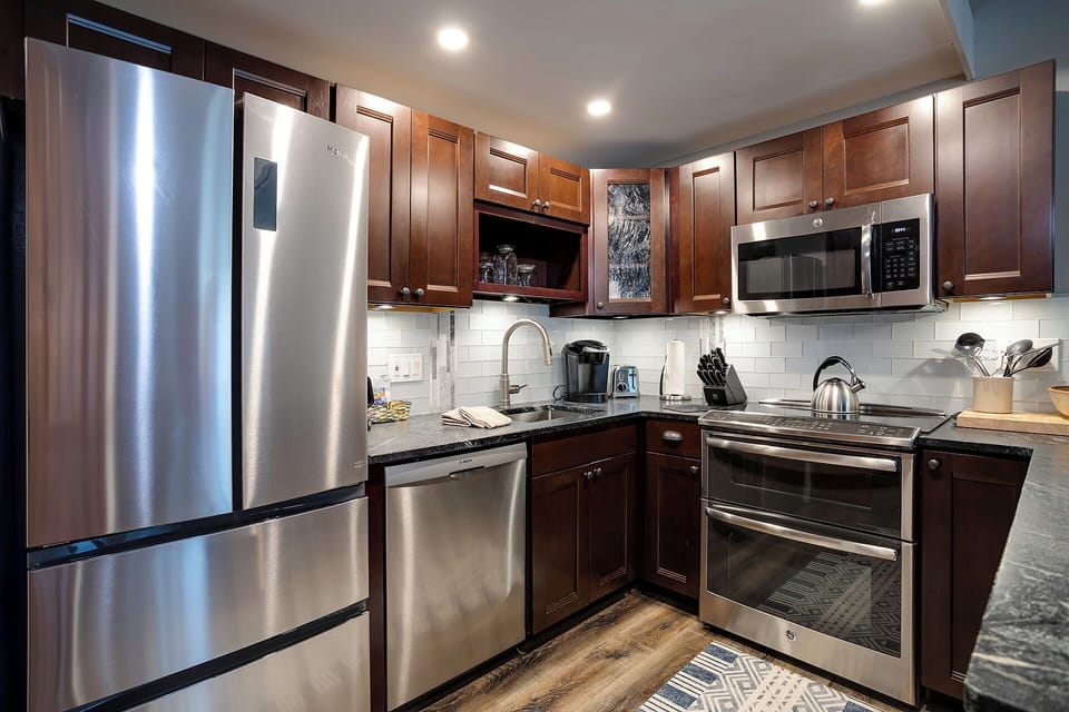 Step into your fully equipped kitchen with gleaming stainless steel appliances and rich wood cabinetry—everything you need to create memorable meals.