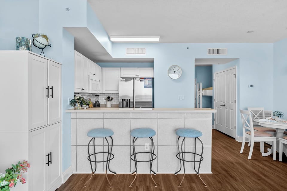 Modern kitchen with a breakfast bar and light blue accents.