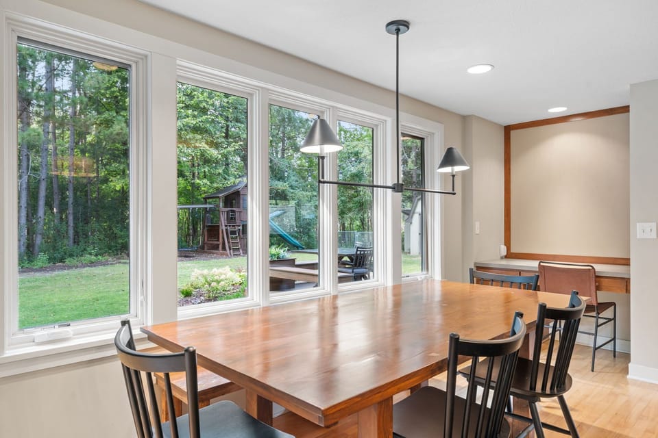 Gather around this beautiful dining table while enjoying views of your private backyard playground through expansive windows.