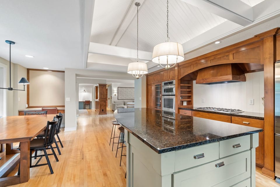 You'll love preparing meals in this stunning gourmet kitchen with granite countertops, premium appliances, and a spacious island perfect for cooking and entertaining.