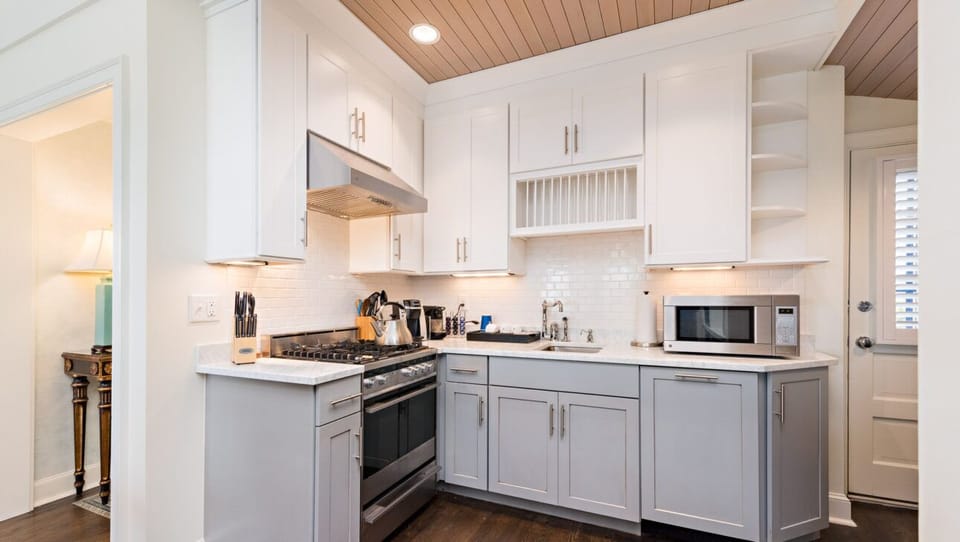 “Bright, modern kitchen with marble counters and coastal charm.”