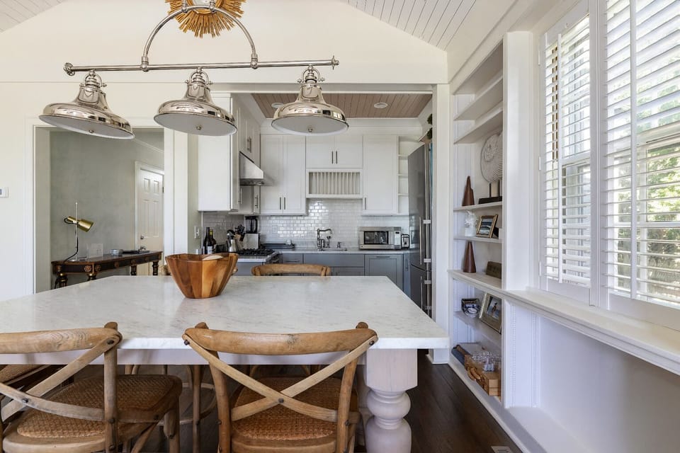 “Bright, modern kitchen with marble counters and coastal charm.”
