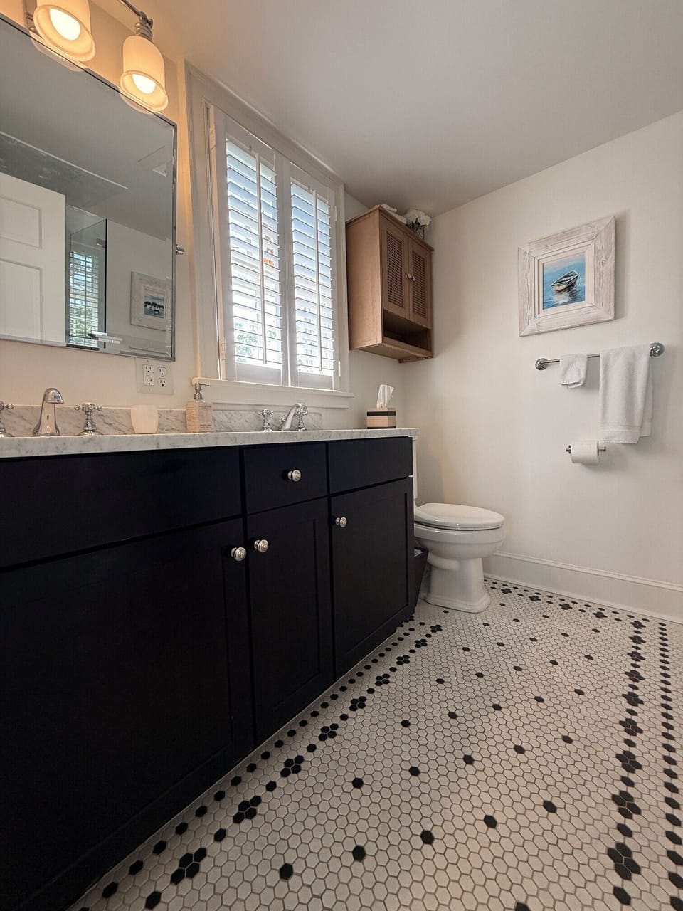 Elegant primary bathroom with double vanity and marble countertops
