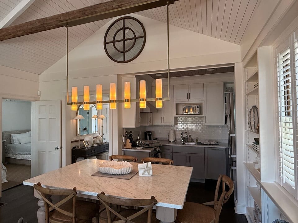 “Bright, modern kitchen with marble counters and coastal charm.”