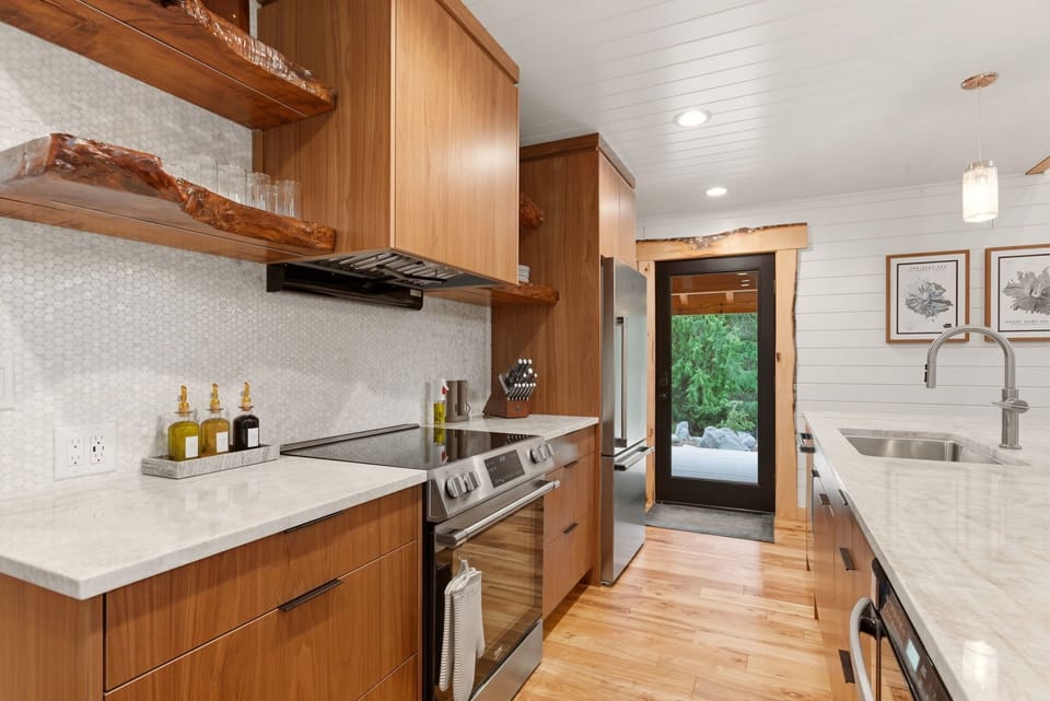 A chef-worthy kitchen with forest views and high-end finishes — cook, gather, and stay awhile.