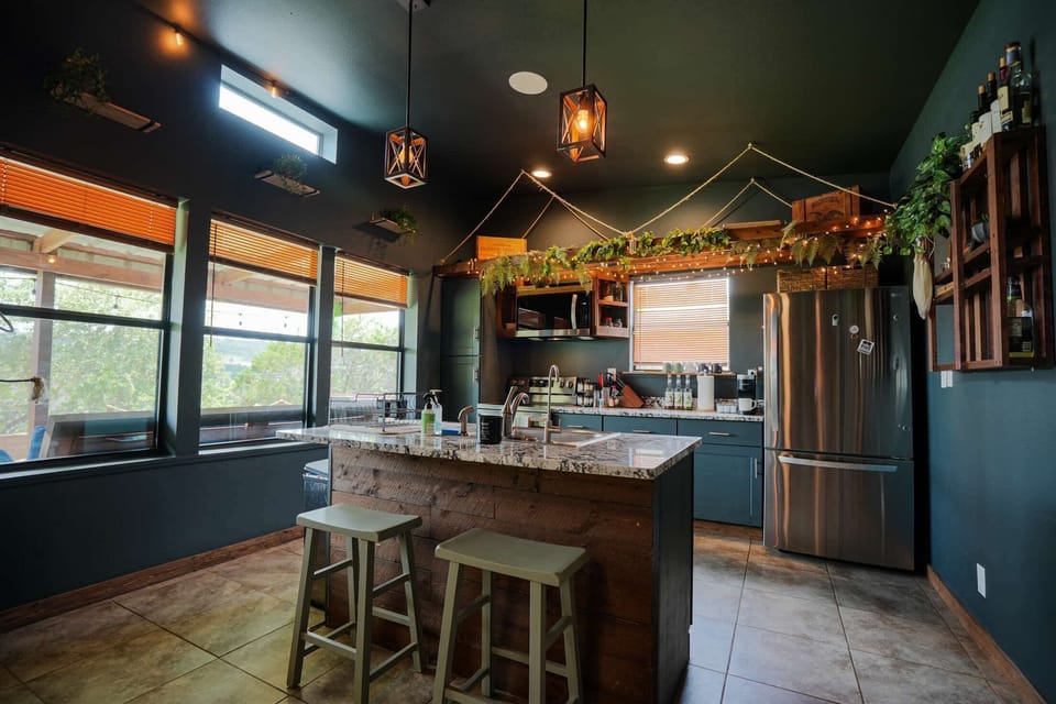 Prepare meals or gather around the island in a kitchen filled with natural light and modern touches, creating a warm and inviting space.