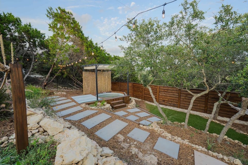 The backyard offers a balance of comfort and style with its pool, string lights, and landscaped touches that make outdoor time enjoyable.