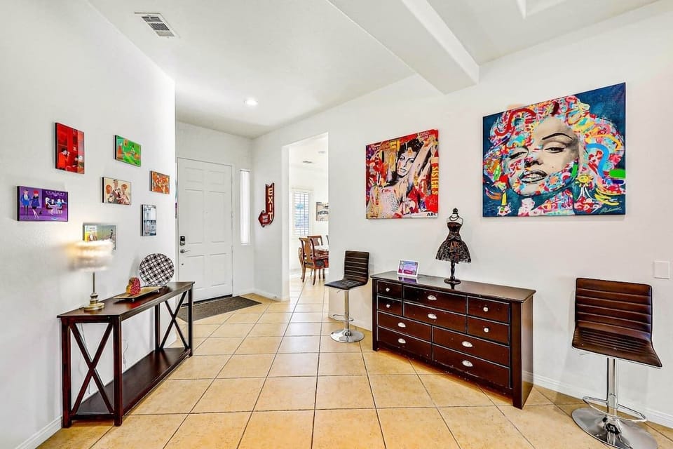 Art-Filled Entryway: A colorful welcome featuring Brigitte Bardot and Marilyn Monroe, leading into Villa Amore’s main living spaces.