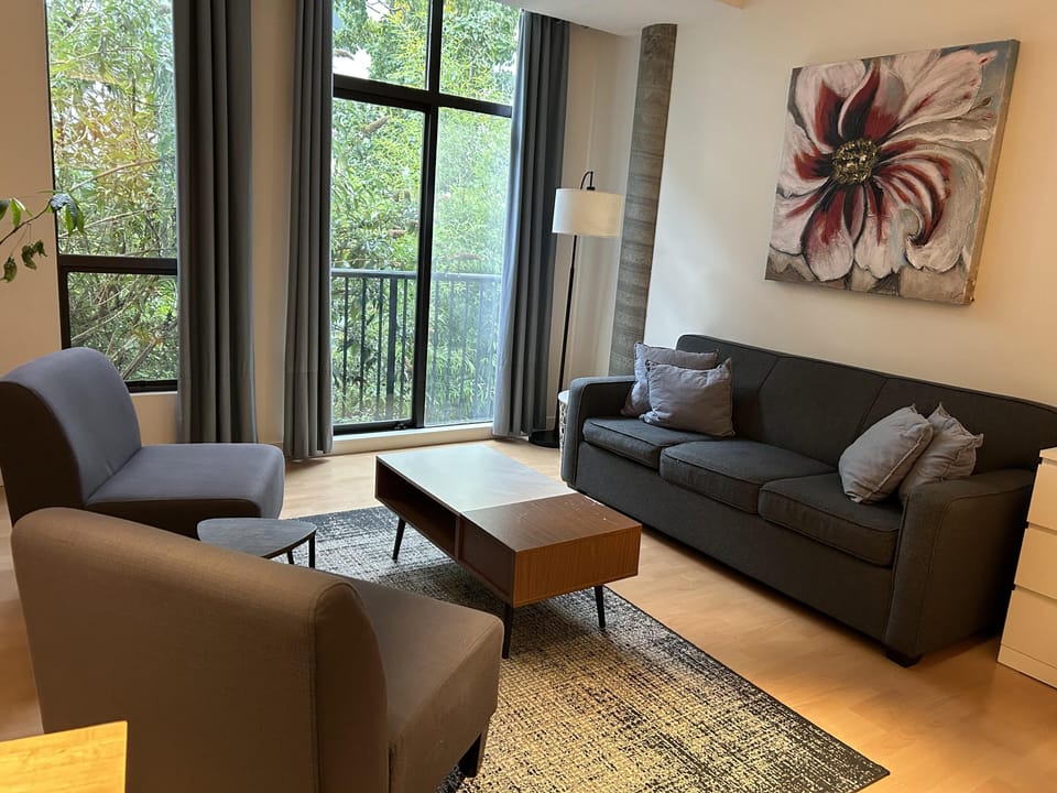 Main seating zone configured with a comfortable sofa bed and armchairs for guest seating or lounging.