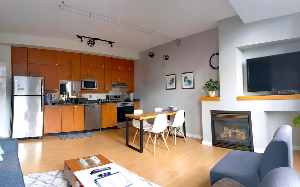 Broad view of the main living space showcasing the seamless transition between the kitchen, dining, and living areas.