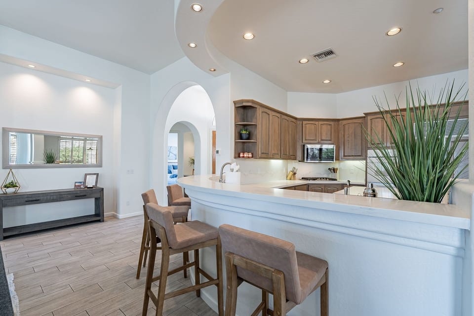 4 barstools flank the kitchen bar