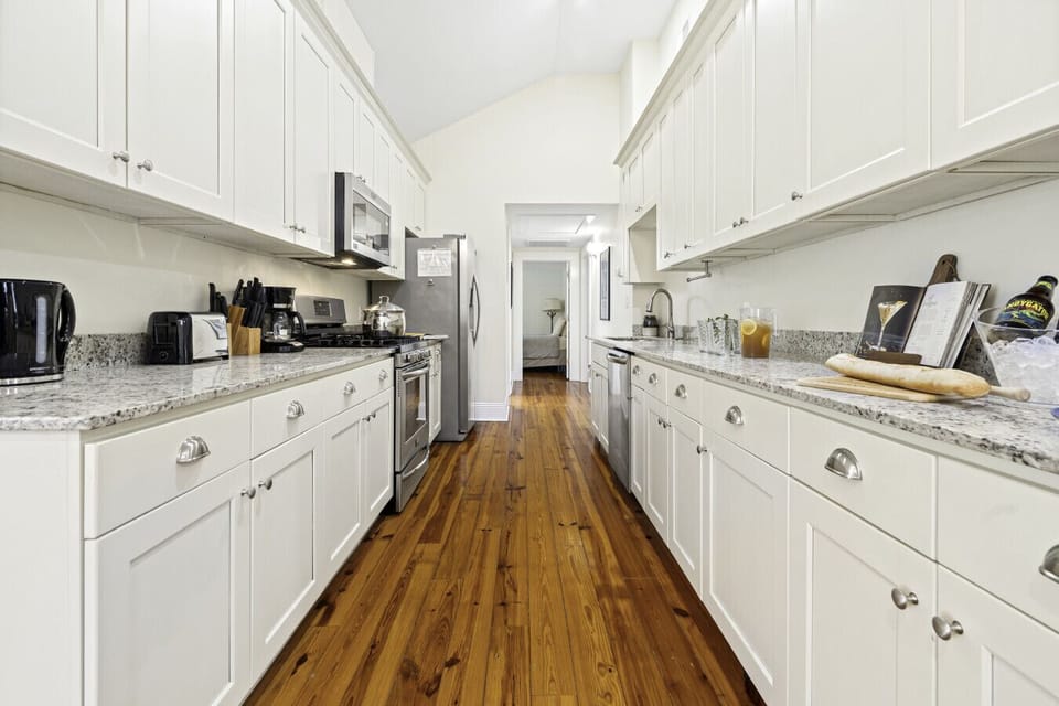 Kitchen | Fully equipped galley-style kitchen with stainless steel appliances, granite countertops, and ample cabinet space