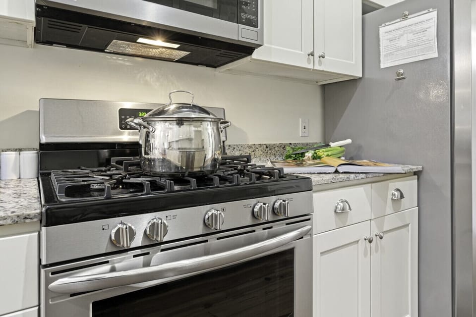 Kitchen | Fully equipped galley-style kitchen with stainless steel appliances, granite countertops, and ample cabinet space