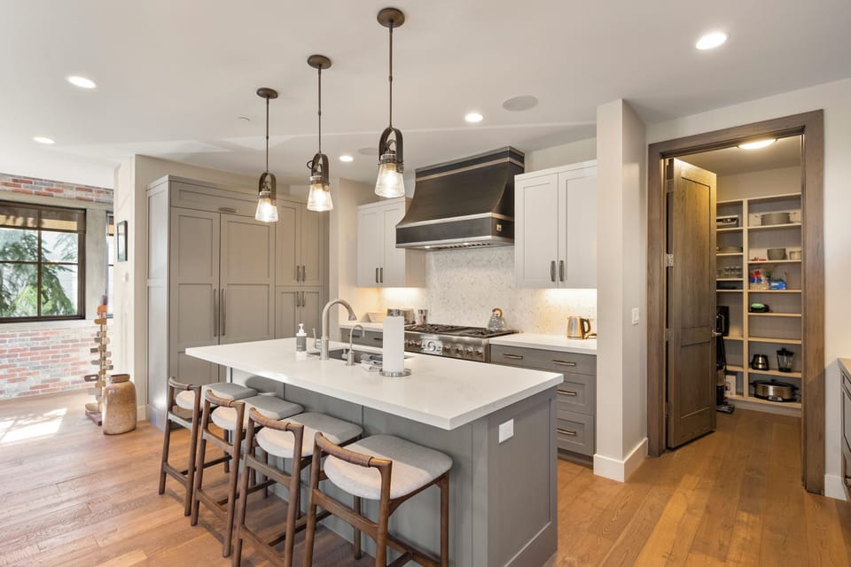 Chef's kitchen with oversized island seating, premium appliances, and seamless flow for entertaining and group dining.