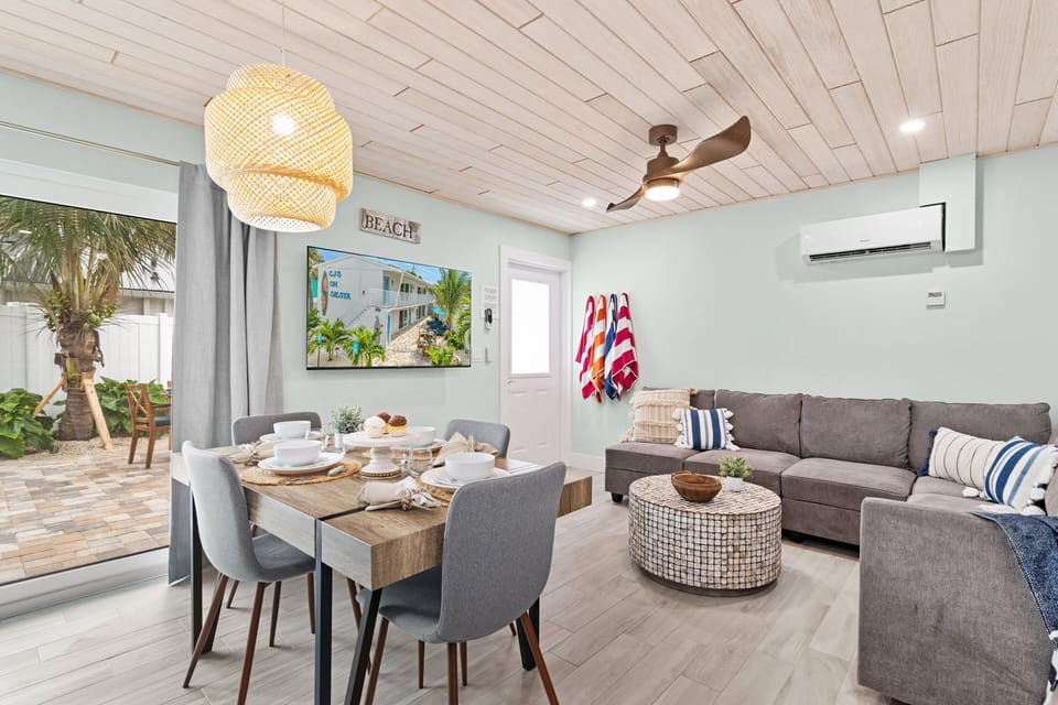 Sea Dream's Living Area, Featuring a Pull-Out Sleeper Couch, A Dining Table, and a Large HD TV