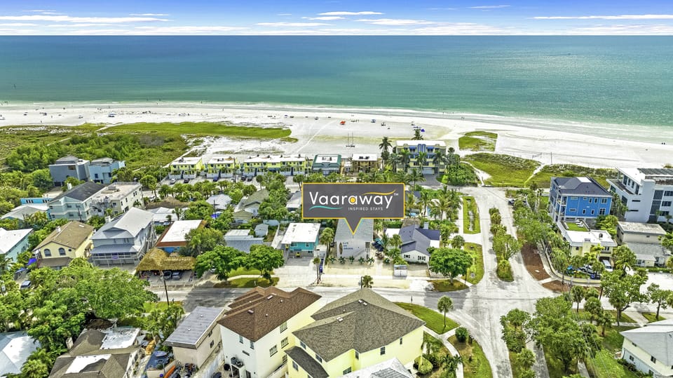 Aerial view capturing the unit and shimmering Gulf beyond.
