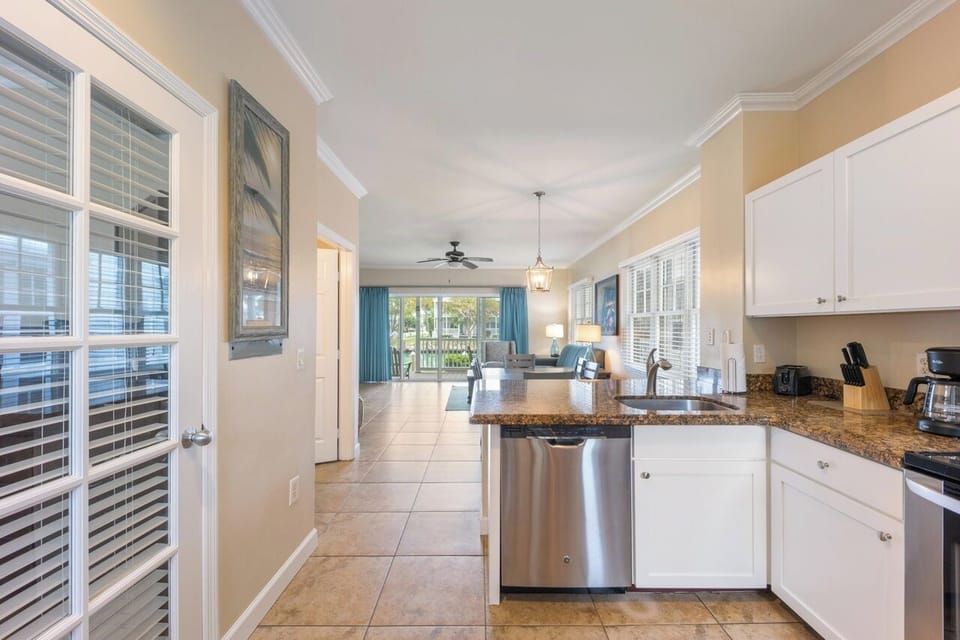 Full kitchen and door to first floor guest bedroom