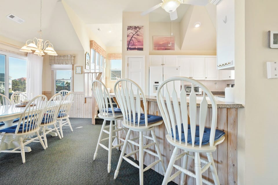 Kitchen: Fully equipped kitchen with modern appliances, breakfast bar seating, and plenty of prep space for family meals.