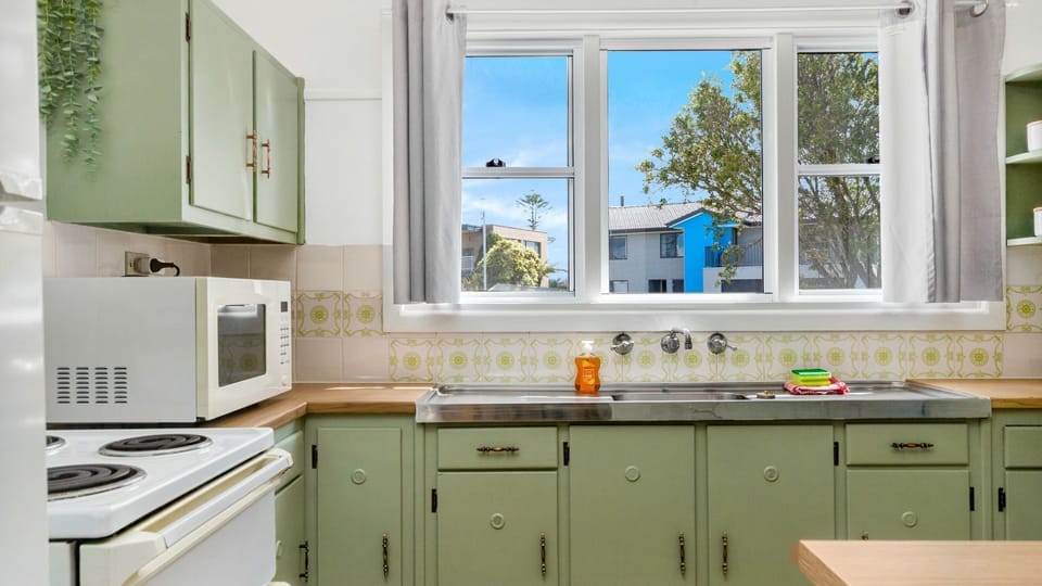 Functional kitchen with modern appliances and homely details.