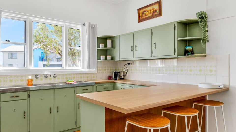Practical cooking space with breakfast counter, perfect for casual dining.