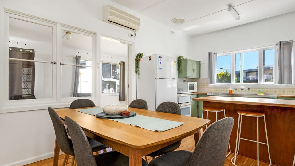 Light-filled dining area with seating for the whole group.