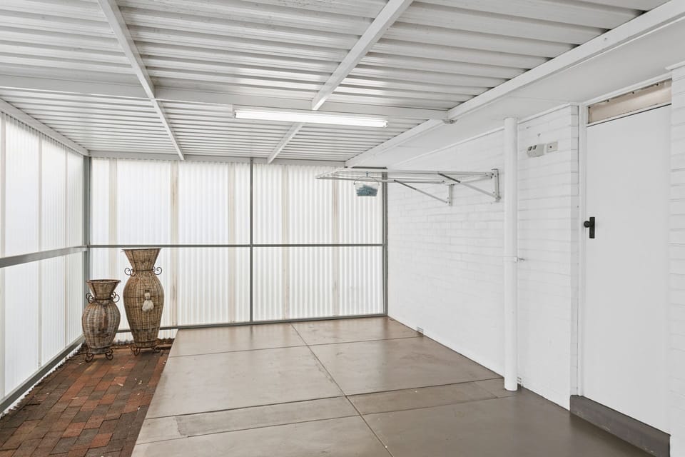 A covered outdoor utility zone - functional for laundry and storage 