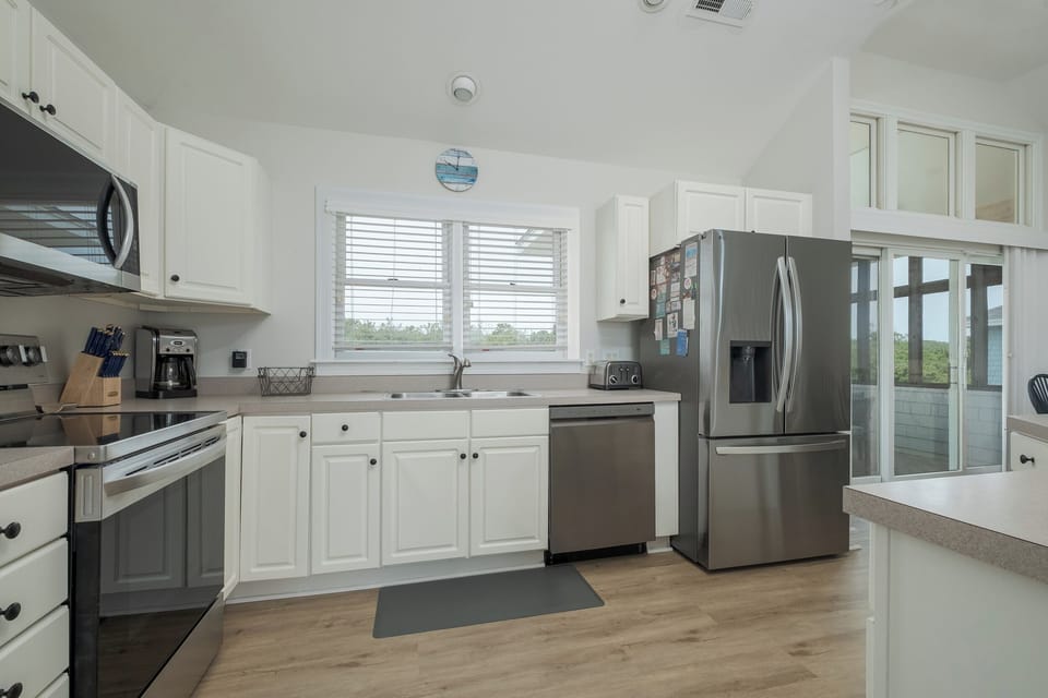 Fully stocked kitchen with stainless steel appliances and plenty of counter space for your culinary creations.