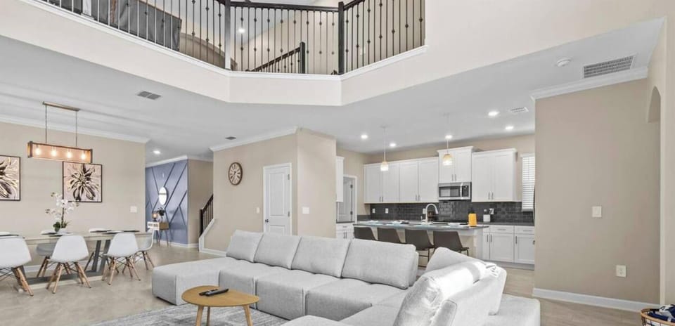 A modern and welcoming living room featuring sleek decor and cozy seating.
