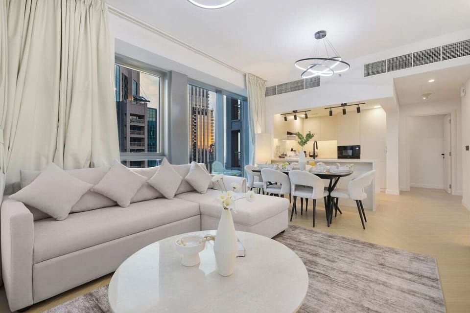 Open-plan living space with soft furnishings and a sleek modern kitchen.