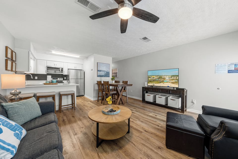 inviting living room with a TV and ceiling fan.