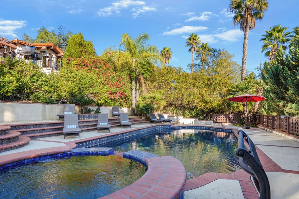 Escape the everyday with a private pool and jacuzzi, surrounded by lush landscaping. (The Ranch)