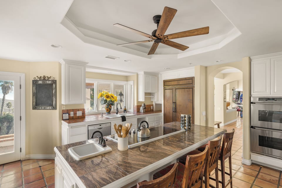Cook and connect in this warm kitchen with a cozy fireplace. (The Ranch)