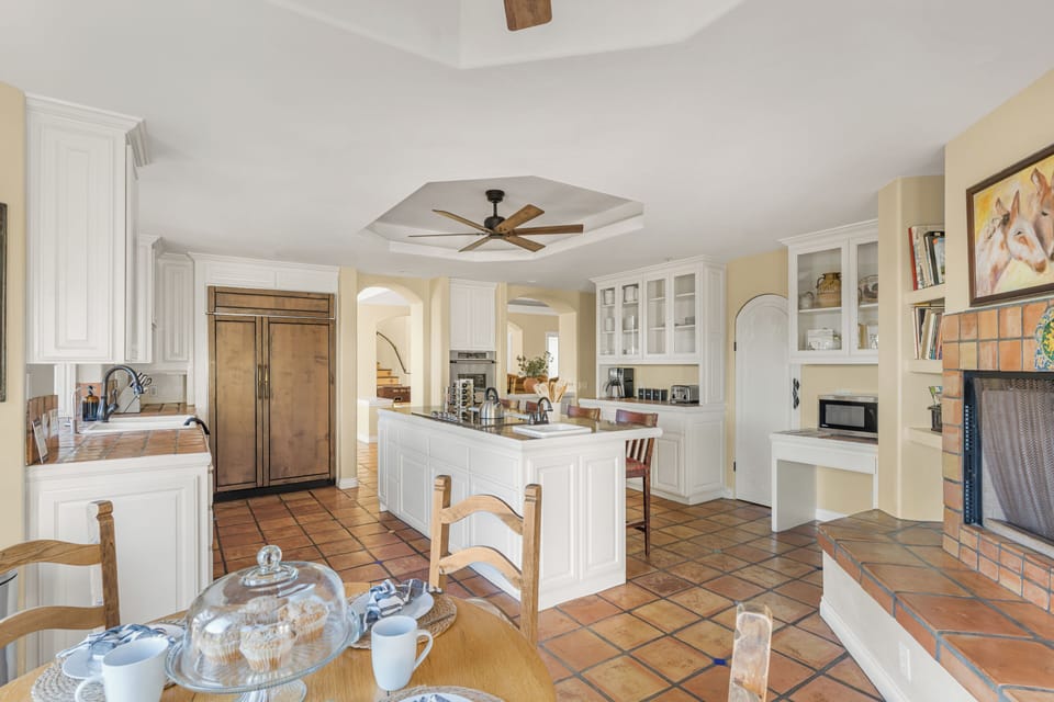 Cook and connect in this warm kitchen with a cozy fireplace. (The Ranch)