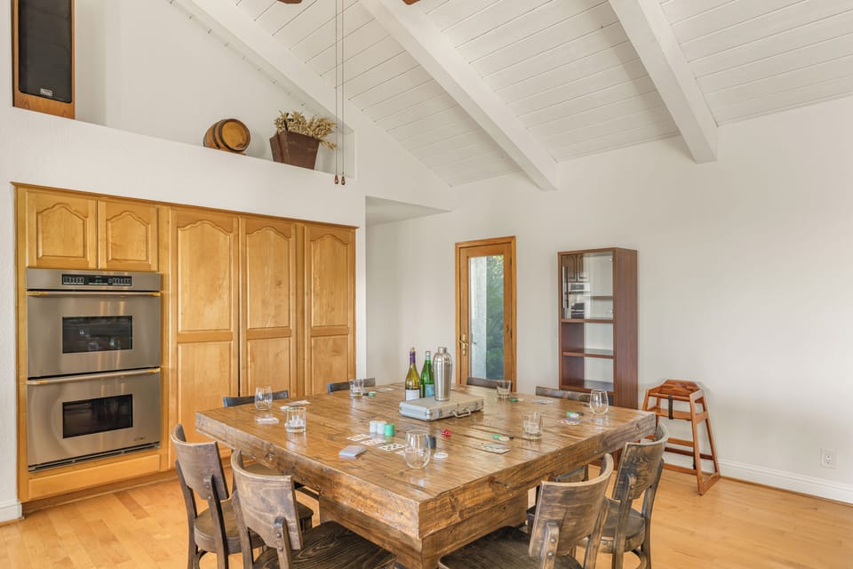 Spacious dining table under vaulted ceilings—perfect for shared meals and game nights.