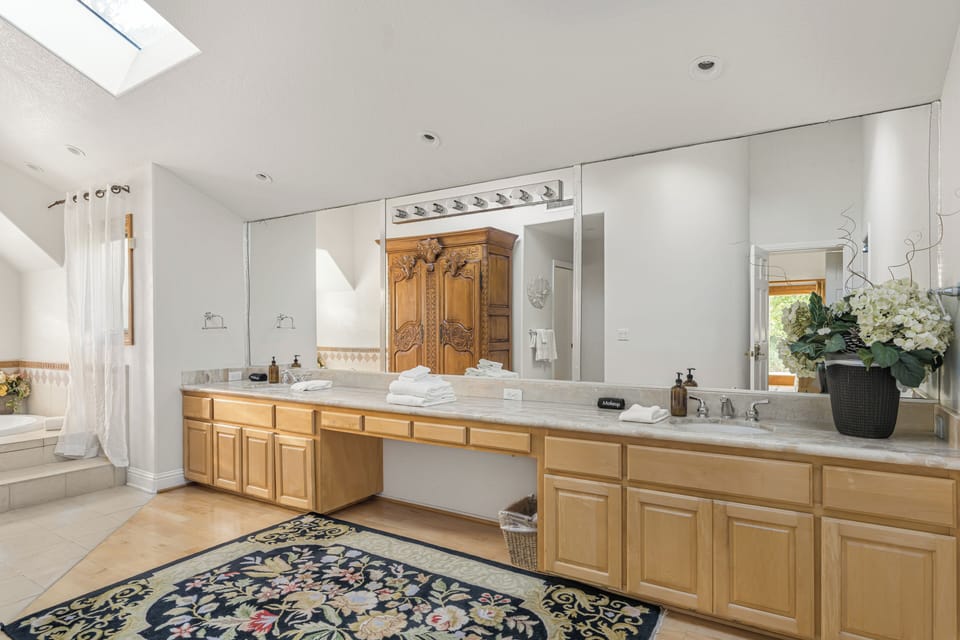 The primary bedroom's ensuite features a double vanity, soaking tub and a stand-up shower.
