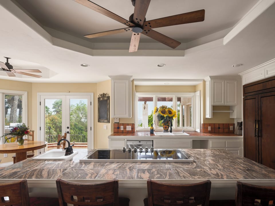 Open-concept layout, featuring a kitchen and dining area with modern appliances.